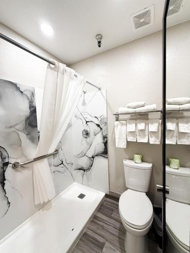 a bathroom with a toilet and a shower at Studio 6 Suites Tucson, AZ Airport Kino Sports Complex in Tucson