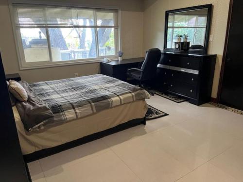 a bedroom with a bed and a dresser and a desk at Specious 6000 sf privat gated villa with View in Fremont