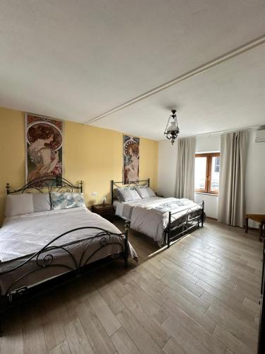 a large bedroom with two beds and a window at Segarati Relax Ca Perdissi in Bardi