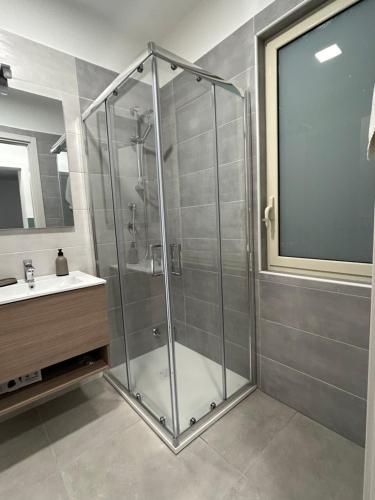 a shower stall in a bathroom with a sink at muretti di macchitella in Gela