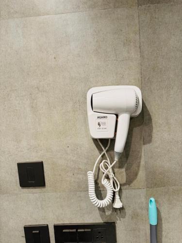 a white phone is hanging on a wall at Supernova Spira 39th floor Sec 94 Noida in Noida