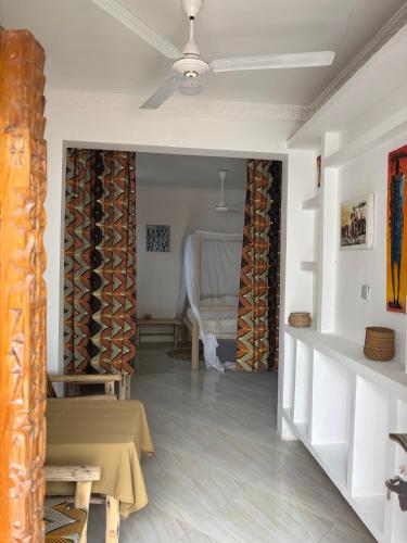 a living room with a table and a chair at Samia House in Jambiani