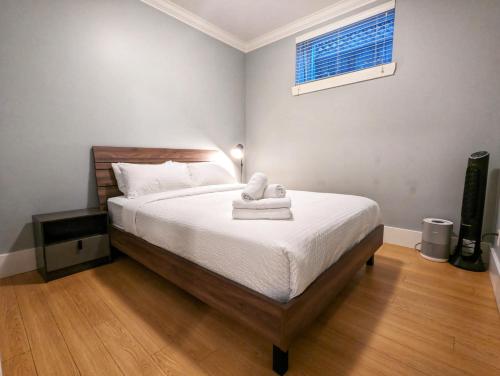 a bedroom with a bed with towels on it at Cozy home in Vancouver in Vancouver