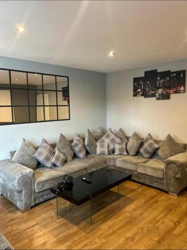 a living room with a couch and a coffee table at The luxe by Viennese Aparts 2 Bedroom! in Bradford