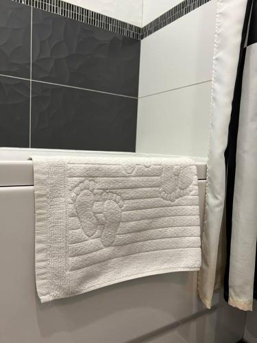 a bathroom with a white towel hanging on a wall at Comfort Apartment In Narva City Center in Narva