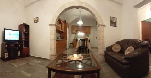 a living room with a couch and a table at Kalotina's House in Kalymnos