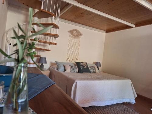 a bedroom with a bed and a vase with a plant at Agriturismo Piccolo Paradiso in Riparbella