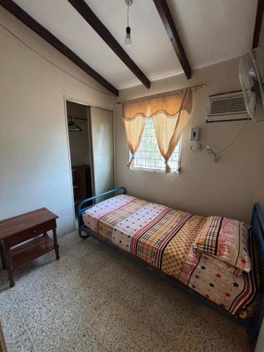 a bedroom with a bed and a window at Casa La Marina Salinas Beach in Salinas
