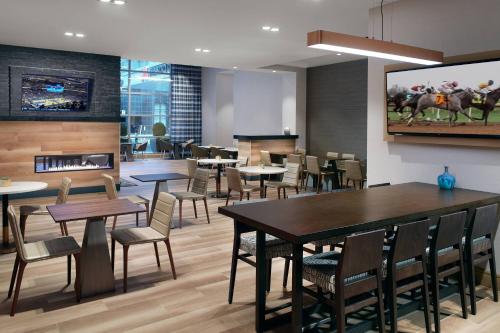 a dining room with tables and chairs and a fireplace at Residence Inn by Marriott Lexington City Center in Lexington