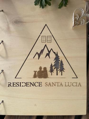 a sign that says resistance santa lucia on a wooden wall at Residence S Lucia - Appartamenti alle porte di Bormio in Valdisotto