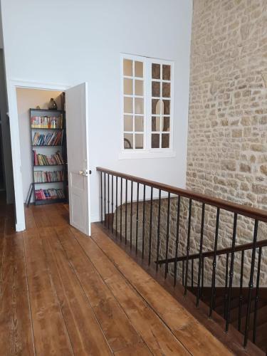 a room with a staircase and a brick wall at La maison de famille gîte classé 4 étoiles in Luçon