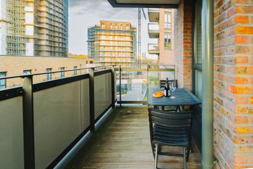 a balcony with a table and chairs on a building at Peaceful Apartment in East End in London