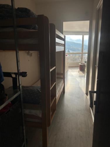 a room with bunk beds with a view of a balcony at Au pied des pistes Côte 2000 - Le Balcon de Villard de Lans in Villard-de-Lans