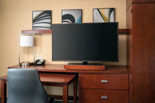 a computer desk with a monitor and a chair at Courtyard by Marriott Glenwood Springs in Glenwood Springs
