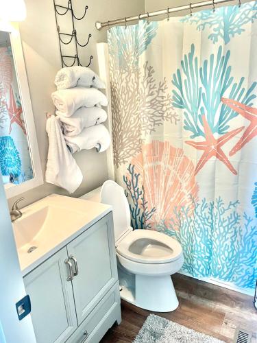 a bathroom with a sink toilet and a shower curtain at The Blue Crab in Myrtle Beach