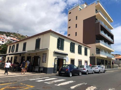 a building with cars parked on the side of a street at Casa Dona Teresa in Santa Cruz