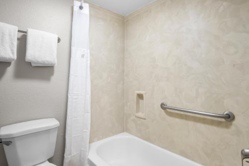a bathroom with a toilet and a shower at Rodeway Inn in Waco