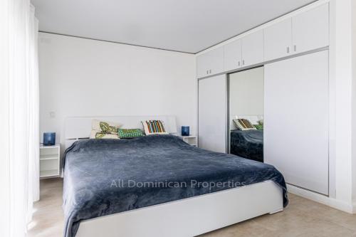a bedroom with a large bed and a large mirror at Sosua private apartments and studios! in Laguna del Higüero
