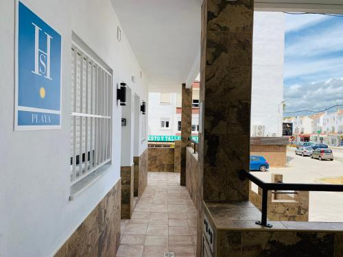 a corridor of a building with a view of a street at DORI ROOMS - Hostal in Tarifa