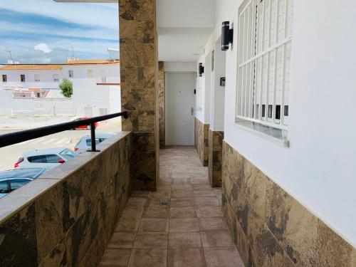 a corridor of a building with a window at DORI ROOMS - Hostal in Tarifa