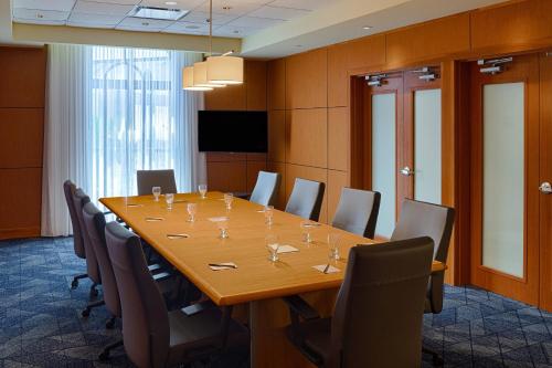 a conference room with a large wooden table and chairs at Courtyard by Marriott Springfield Downtown in Springfield