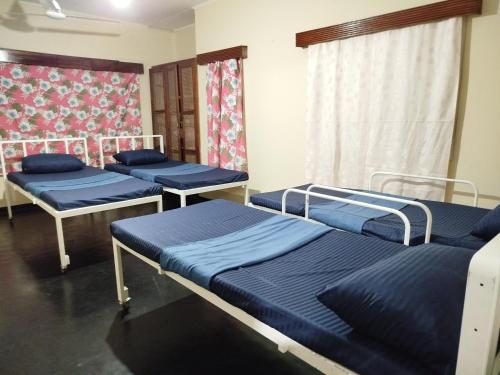 a room with three bunk beds in it at Holy Spirit Mission Camps in Mount Lavinia