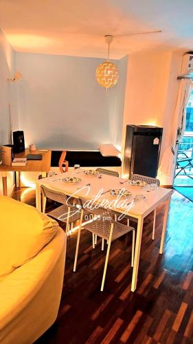 a living room with a table with a laptop on it at River View Active 6 in Bangkok