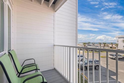 a balcony with chairs and a view of a parking lot at Plantation East #2212 in Gulf Shores