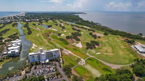 an aerial view of a golf course next to the water at Plantation East #2212 in Gulf Shores