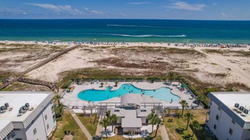 an aerial view of a pool and the beach at Plantation East #2212 in Gulf Shores
