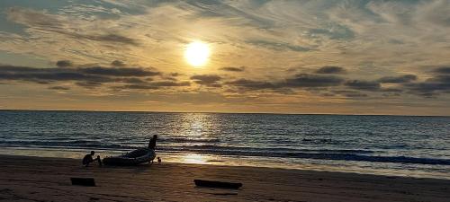 a man and a child on a beach with a boat at Oceanfront Retreat in Casablanca in Same