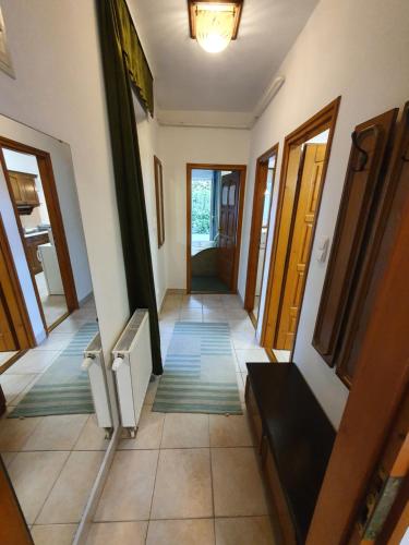 a hallway of a house with doors and tile floors at Arizona apartman in Siófok