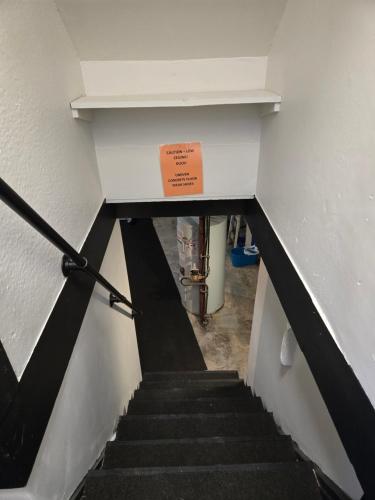 a stair case with a sign on the top of it at Minutes to Downtown & Ideal for Long-term Stays in Kingston
