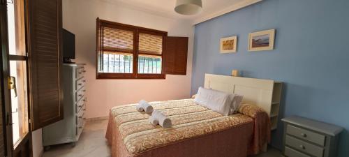 a bedroom with a bed with two towels on it at La Casita de Juana in Málaga