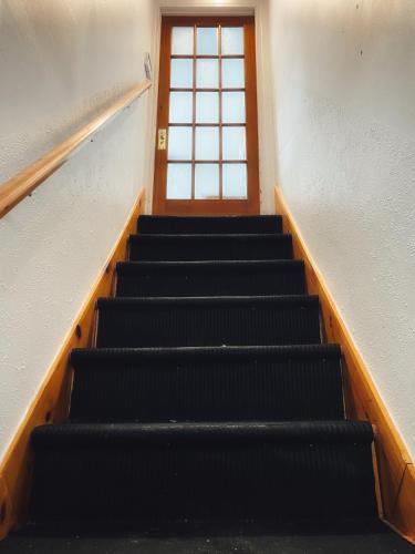 an empty stairs in a building with a window at Quebec Grand Appartement by Hébergements DCL in Quebec City
