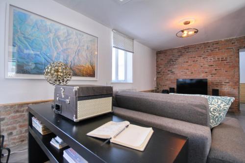 a living room with a couch and a table at Quebec Grand Appartement by Hébergements DCL in Quebec City