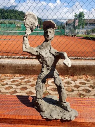 a metal statue of a boy playing baseball at Weiss Sport & Relax Apartment in Rečica ob Savinji