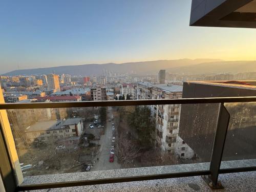 a view of a city from a balcony at Cosy Nest in Tbilisi City