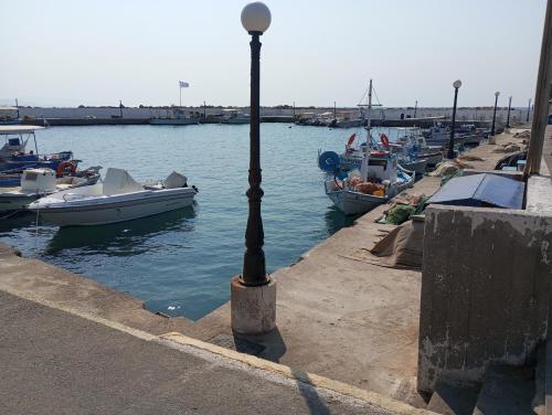 a street light next to a harbor with boats at Dora's House in Chios