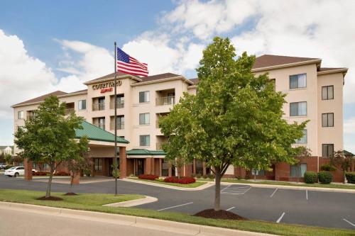 a hotel with an american flag on top of it at Courtyard by Marriott Dayton Beavercreek in Beavercreek