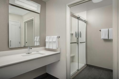 a bathroom with a sink and a shower at Courtyard by Marriott Dayton Beavercreek in Beavercreek