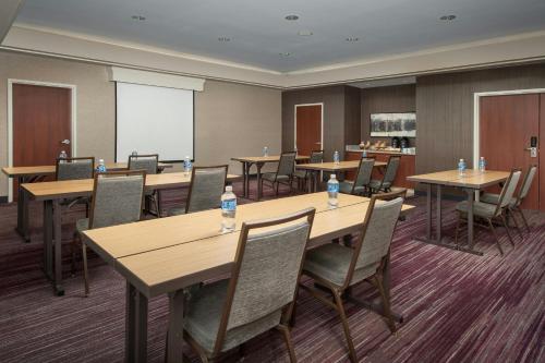 a conference room with wooden tables and chairs at Courtyard by Marriott Dayton Beavercreek in Beavercreek