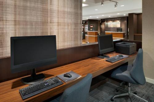 an office with a desk with a computer and two monitors at Courtyard by Marriott Dayton Beavercreek in Beavercreek