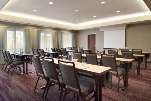 a conference room with tables and chairs and a whiteboard at Courtyard by Marriott Dayton Beavercreek in Beavercreek