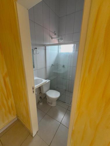 a bathroom with a toilet and a shower and a sink at Rosa blue in Imbituba
