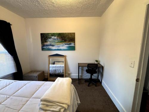 a bedroom with a bed and a table and a mirror at 3 bed unit Retreat near Ann Arbor King Bed in Ypsilanti