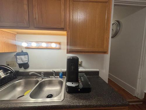 a kitchen sink with a coffee maker on the counter at 3 bed unit Retreat near Ann Arbor King Bed in Ypsilanti
