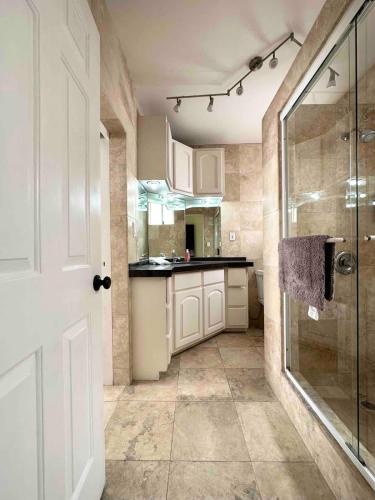 a bathroom with a shower and a glass shower backdoor at Real Del Mar Tijuana Apt for 2 guests in Tijuana