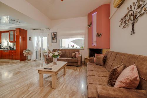 a living room with a couch and a table at Satisfy Holiday Escape Apartment for 2-7 Pax in Limín Khersonísou