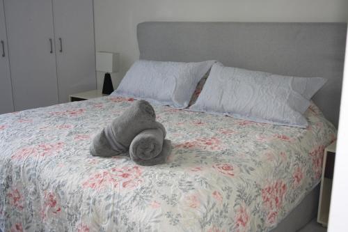 a stuffed animal is laying on a bed at 78796 Cozy unit by the Pool, Fiber Optic, 70m to Ocean in Progreso